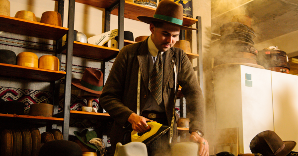 A man irons velvet hats