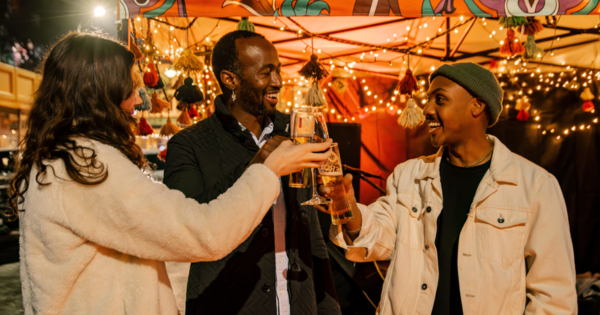 Three People Cheers their Drinks