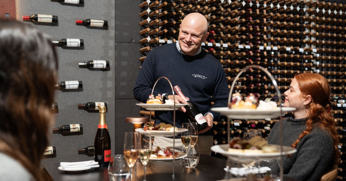 A man telling a group of people about wine